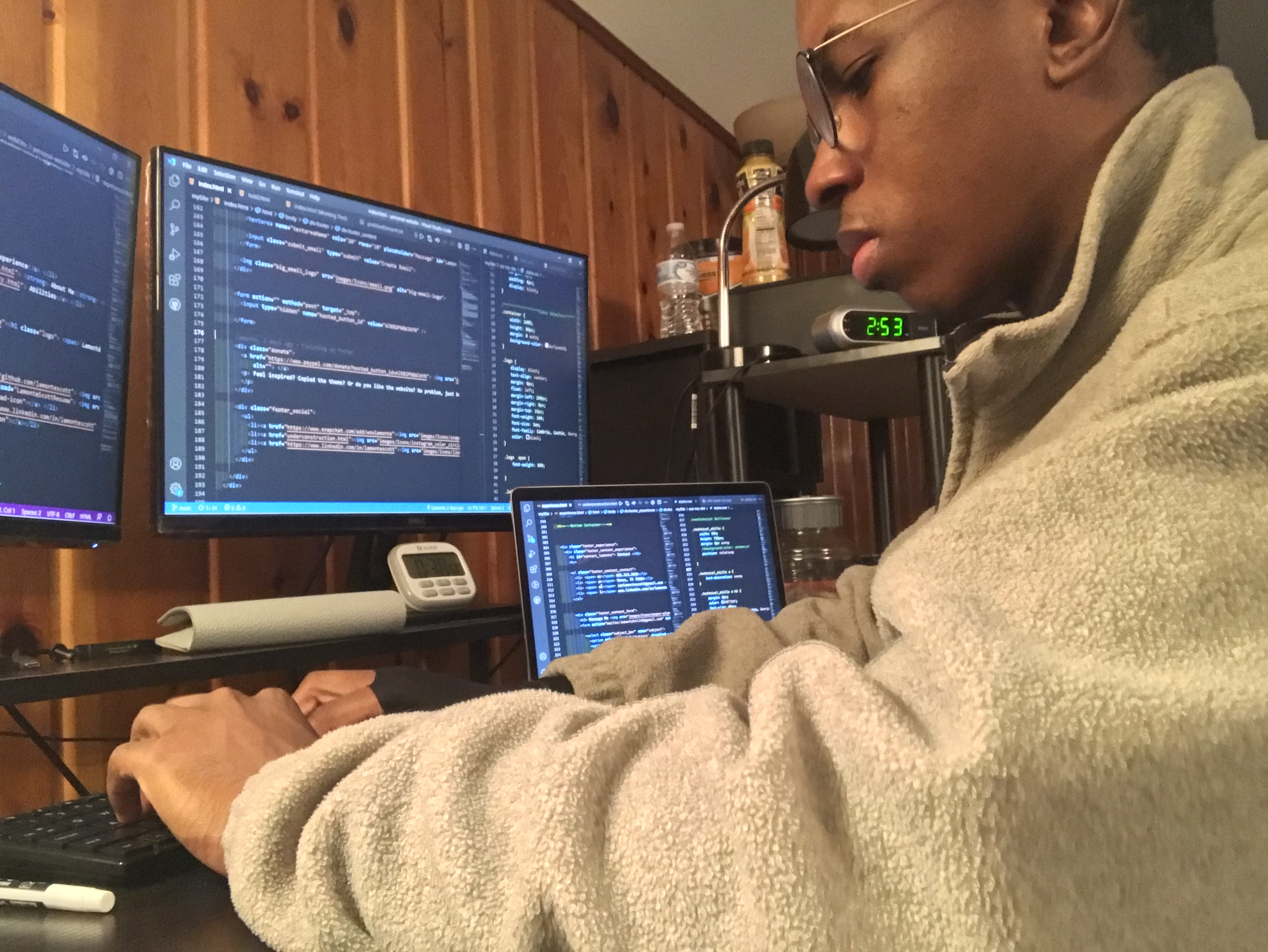 Lamonte Scott writting on computer focus and writing source code.